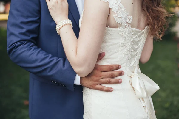 Matrimonio. Lo sposo in un costume e la sposa in un vestito bianco stan — Foto Stock