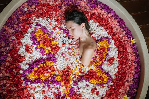 Zbliżenie portret kobieta relaks w rundzie duża kąpiel z tropikalnych kwiatów. Niesamowita ogromna wanna w tropikalnej dżungli. Organic Pielęgnacja skóry w gorącej kąpieli w luksusowym uzdrowisku. — Zdjęcie stockowe