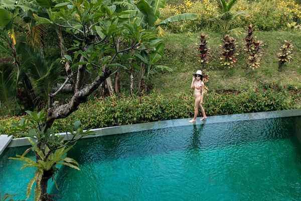 Medence Szélén Sétál Élvezi Dzsungelkilátást Bézs Bikiniben Kalapban Nyaralási Koncepció — Stock Fotó
