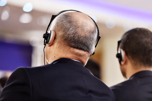 Man using headphones for translation