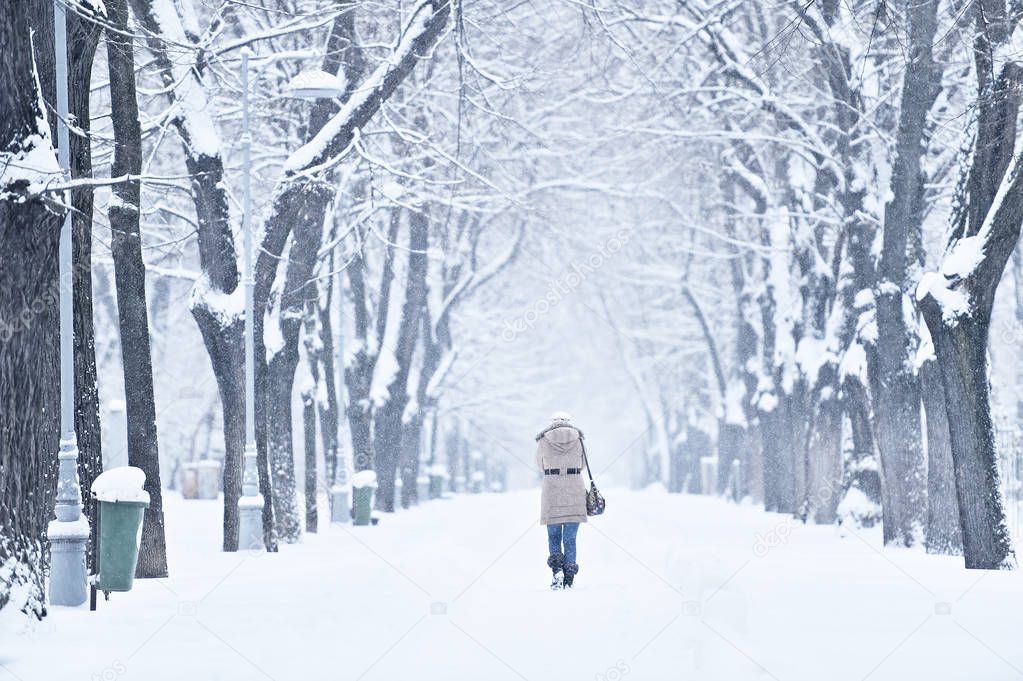 People walking on snow covered sidewalk 