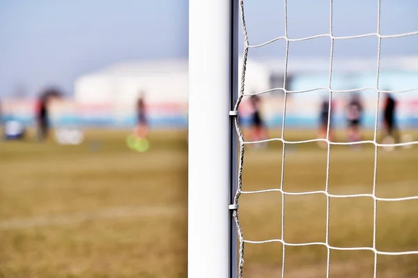 Soccer goalpost and players training — Stock Photo, Image