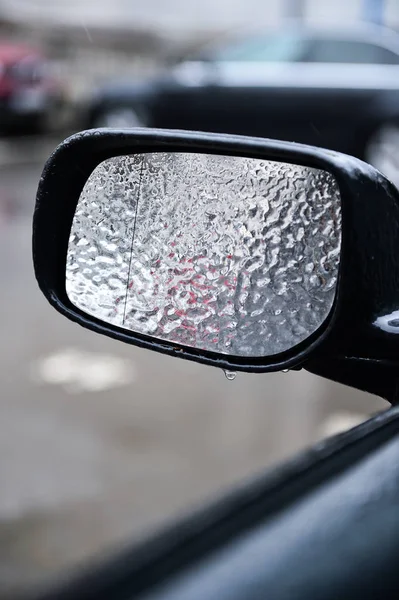 Vehicle mirror covered in ice during freezing rain — Stock Photo, Image