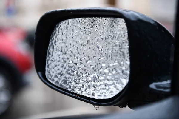Vehicle mirror covered in ice during freezing rain — Stock Photo, Image