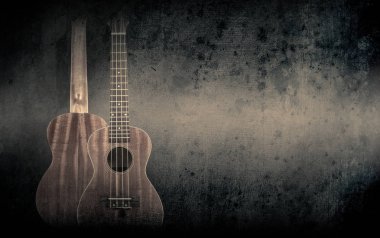 Siyah arka plan üzerine turuncu bir akustik gitar parçası.