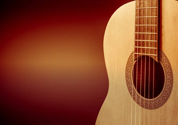 Siyah arka plan üzerine turuncu bir akustik gitar parçası. — Stok fotoğraf