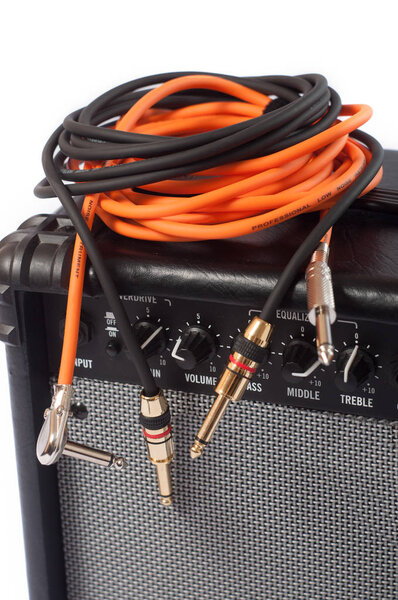 Close-up of guitar amplifier with jack cable.