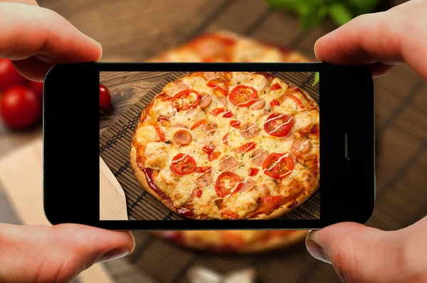 Hot pizza slice with melting cheese on a rustic wooden table