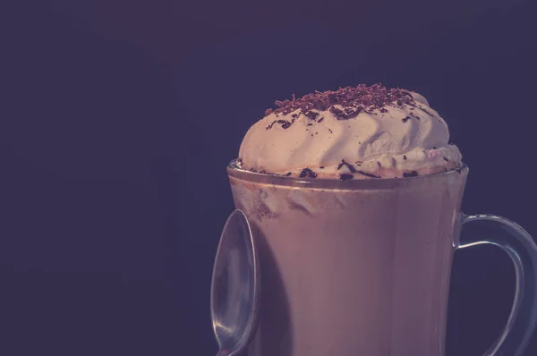 Hot viennese coffee with whipped cream on dark background