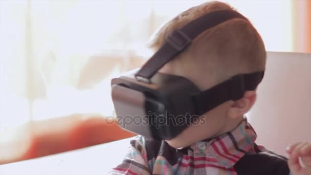 Μικρό αγόρι χρήση εικονικής πραγματικότητας ακουστικό κράνους, αυτός πολύ εντυπωσιασμένος — Αρχείο Βίντεο