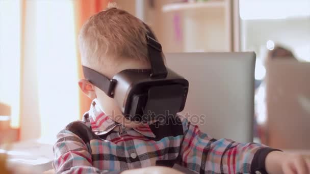 Little boy use virtual reality headset helmet, he very impressed — Stock Video