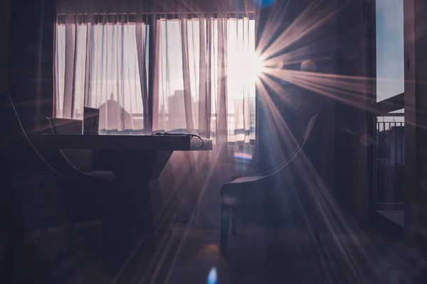 Sunlight enters through the window of a room