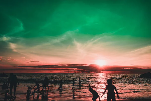 Dramatik gökyüzü ve bulutlar. Çocuklarıyla şehir sakinleri deniz kenarında bir hafta sonunun tadını çıkarıyorlar.. 