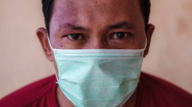 Koronavirüs, covid-19 ve kuş gribi gibi virüslerin neden olduğu hastalıkların yayılmasını tahmin etmek için Asyalı bir maske takıyor. Coronavirus pendemic 2020