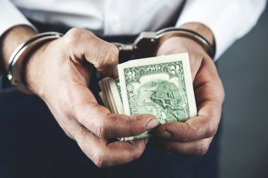 Parayla kelepçelenmiş adam.