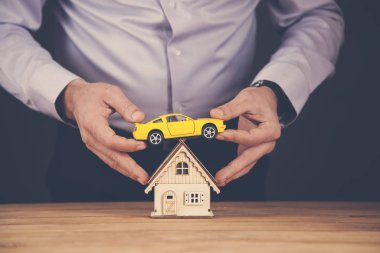 man hand house with car model