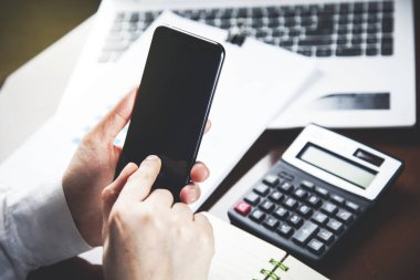 woman hand smart phone with calculator