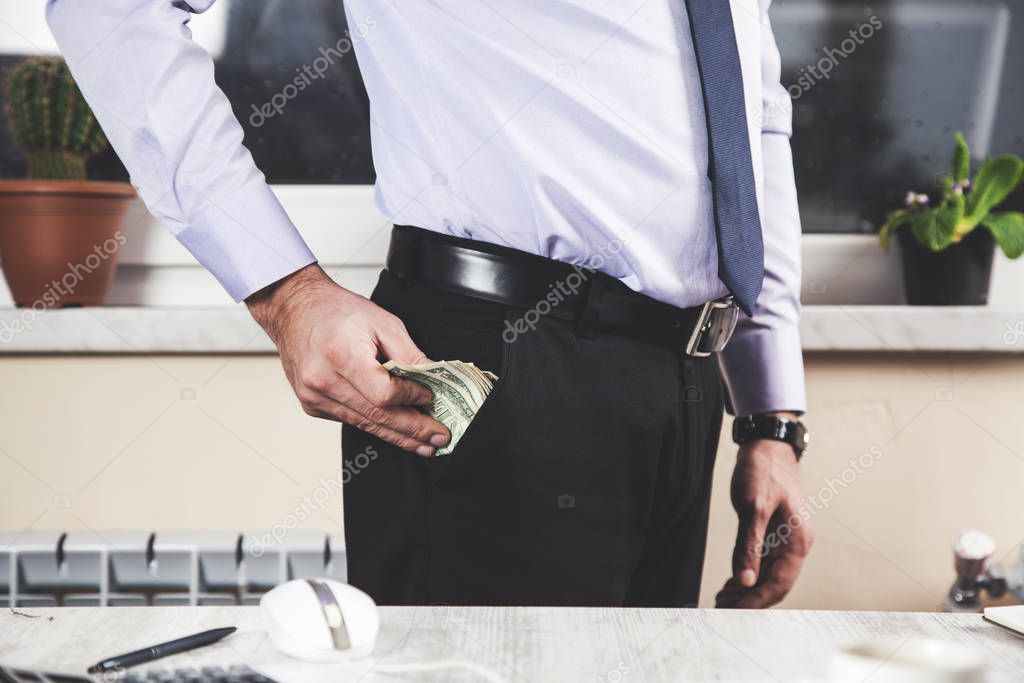 business man hand holding  money on pocket