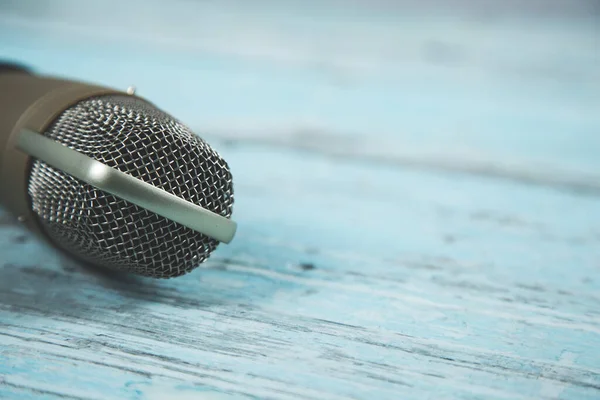 stock image microphone on the  blue wooden table background