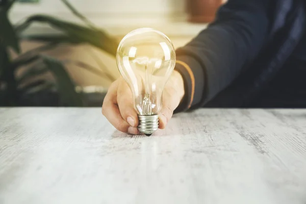 man hand idea or light bulb on desk