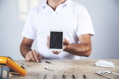 Çalışan ahşap masa üzerinde testçi ile çalışan el telefonu
