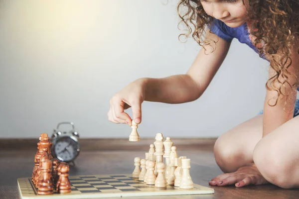 baby girl hand chess on the ground