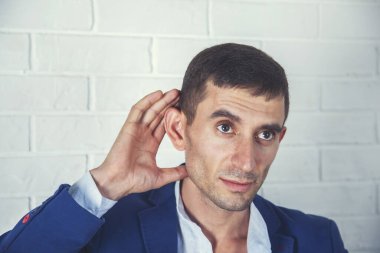 Gri arka planda el ele tutuşan genç iş adamı