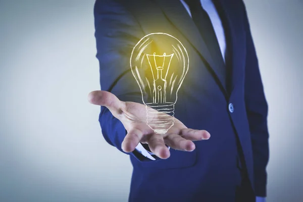 man hand light bulb in screen on gray background