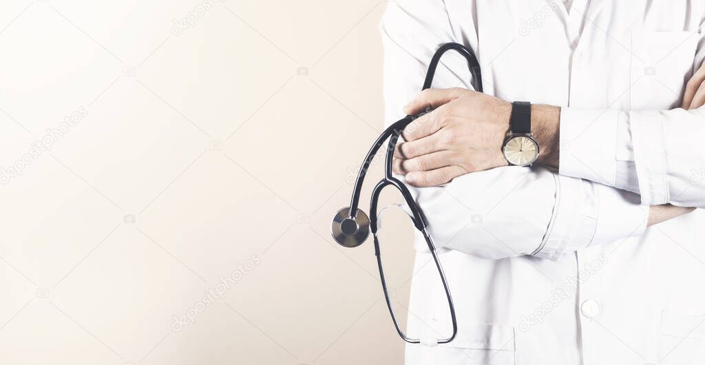 Confident doctor posing with arms crossed and stethoscope