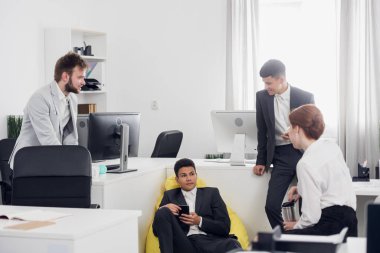 Men and woman have a break time, they relax and talk to each other