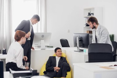 Office workers have a break time and talk during working day in the office