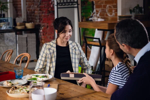 A celebration dinner, young family is exchanging presents — Stock Photo, Image