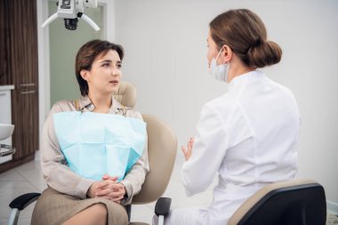 Yıllık kontrolü sırasında doktoruyla konuşan bir kadın.