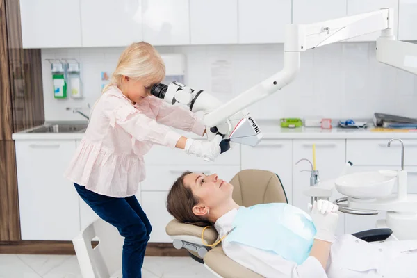 A child acting as a dentist doctor playing with dental tools, having silicone gloves on — Stock Photo, Image