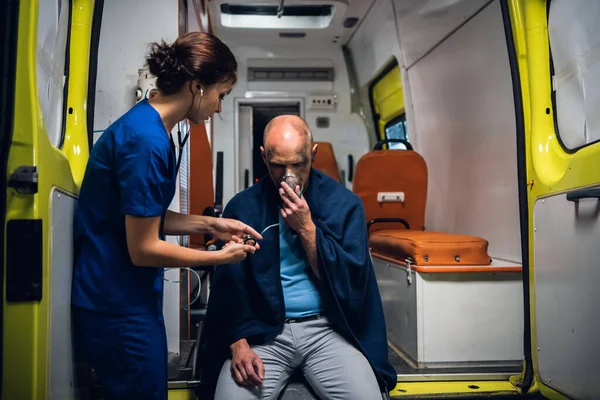 Медсестра со стетоскопом проверяет сердцебиение своих пациентов. — стоковое фото