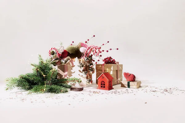 Christmas composition with crickets, toys a house and branches, white background