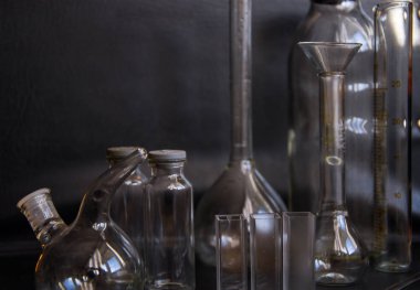 Siyah arka plandaki cam kimya laboratuarı ekipmanlarının analizi için farklı bir laboratuvar cam ve sıvıyla ayarlandı. Kimya Laboratuarı konsepti