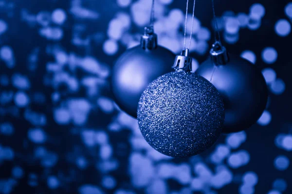 Christmas ornament balls  over classic blue pantone Holiday Background, Copy Space, place for text