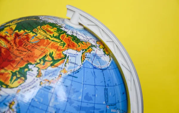 globe sphere on the yellow background, place for text