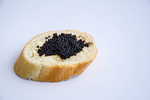 one sandwich with black caviar isolated on the white background