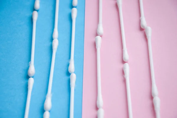 Row of ears sticks on blue and pink. Close up. — Stock Photo, Image