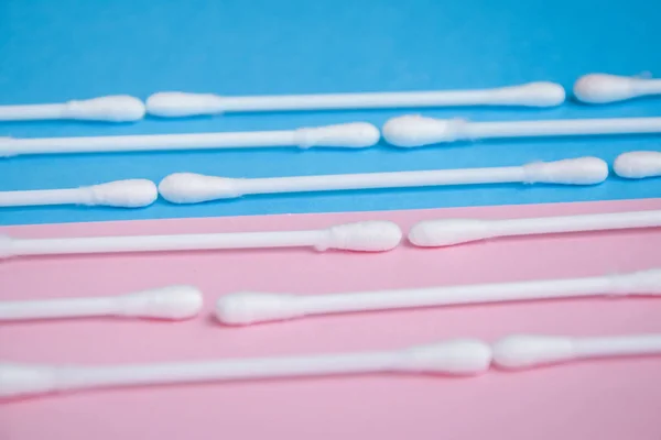 Row of ears sticks on blue and pink. Close up. — Stock Photo, Image