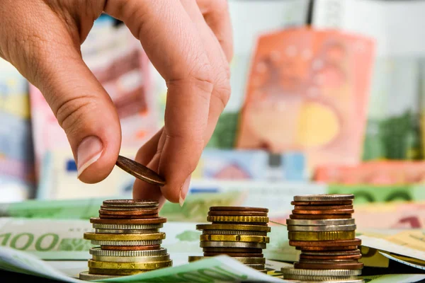 Hand putting coin to stack of coins. Business and Finance or Saving money concept