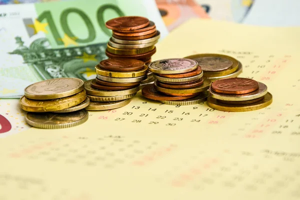 stack of coins on calendar, closeup shot, for finance background
