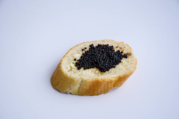 one sandwich with black caviar isolated on the white background Luxurious culinary delicacy