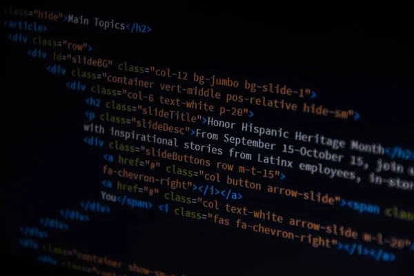 Source code or HTML code on screen of computer, Close up css code on monitor screen with black background, binary code on dark background