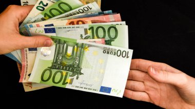 Avro verilmesi, siyah arka planda izole edilmiş avrolar, Avro tutmak, Ticaret Teması, 100 banknot