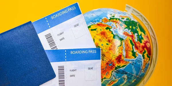 The airplane tickets with globe. Travel concept Passport on a map of the world. Globe map on a background.Departure and Arrival, international passport, airplane ticket