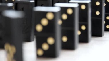 Close up of black dominoes selective focus, slow motion, table board game