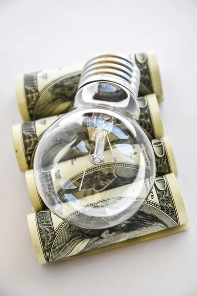 Money saved in different kinds of light bulbs, Lamps on the usd american dollar background, Energy saving lamp, money, finance, savings concept and idea